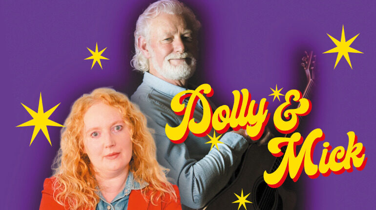 A man holds a guitar as he looks directly at the camera. He is wearing a shirt aged 50 with grey hair. A mature woman looks on with a slightly disgruntled face. The background is purple with three bright yellow stars dotted around. The show title is in bright yellow font and says Dolly & Mick