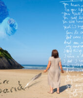 Blue Sky. A woman stands on a beach, we can see the back if her head. We see the side of a cliff. The image has text on it. The text is handwritten, like note in a scrap book. Oprah is in the sky, her image is faint. Oprah is pointing at the woman on the beach. We see the edge of a cliff. This is where Oprah is appearing above to the right of the screen.